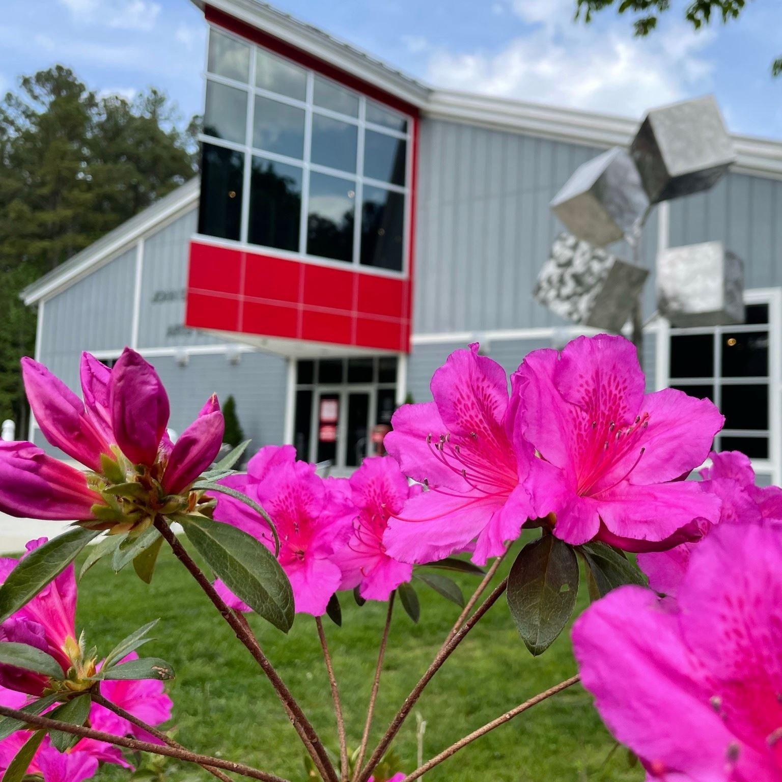 Annmarie Sculpture Garden arts building with pink flowers