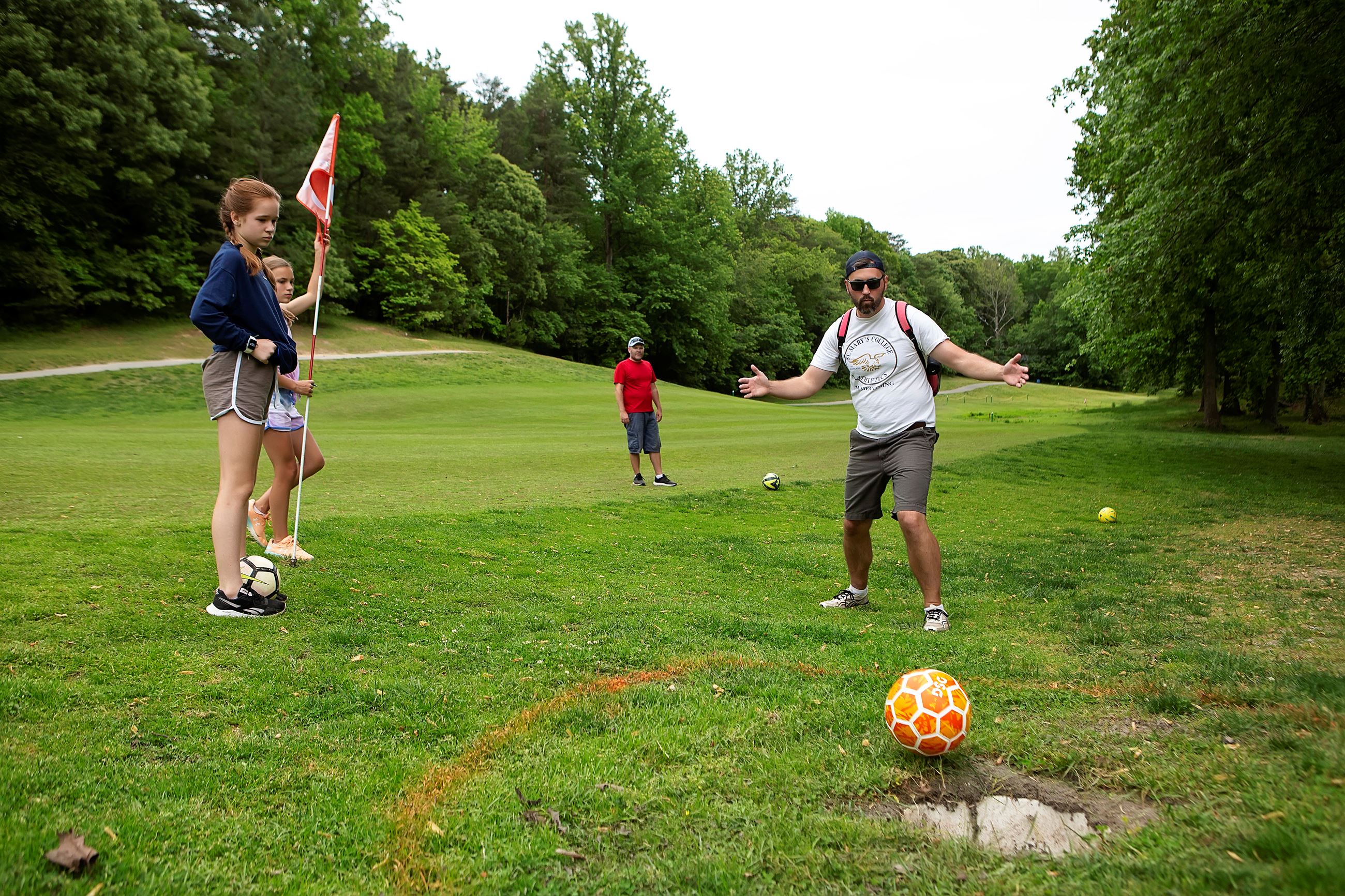 Parents and children playing foot golf at Chesapeake Hills