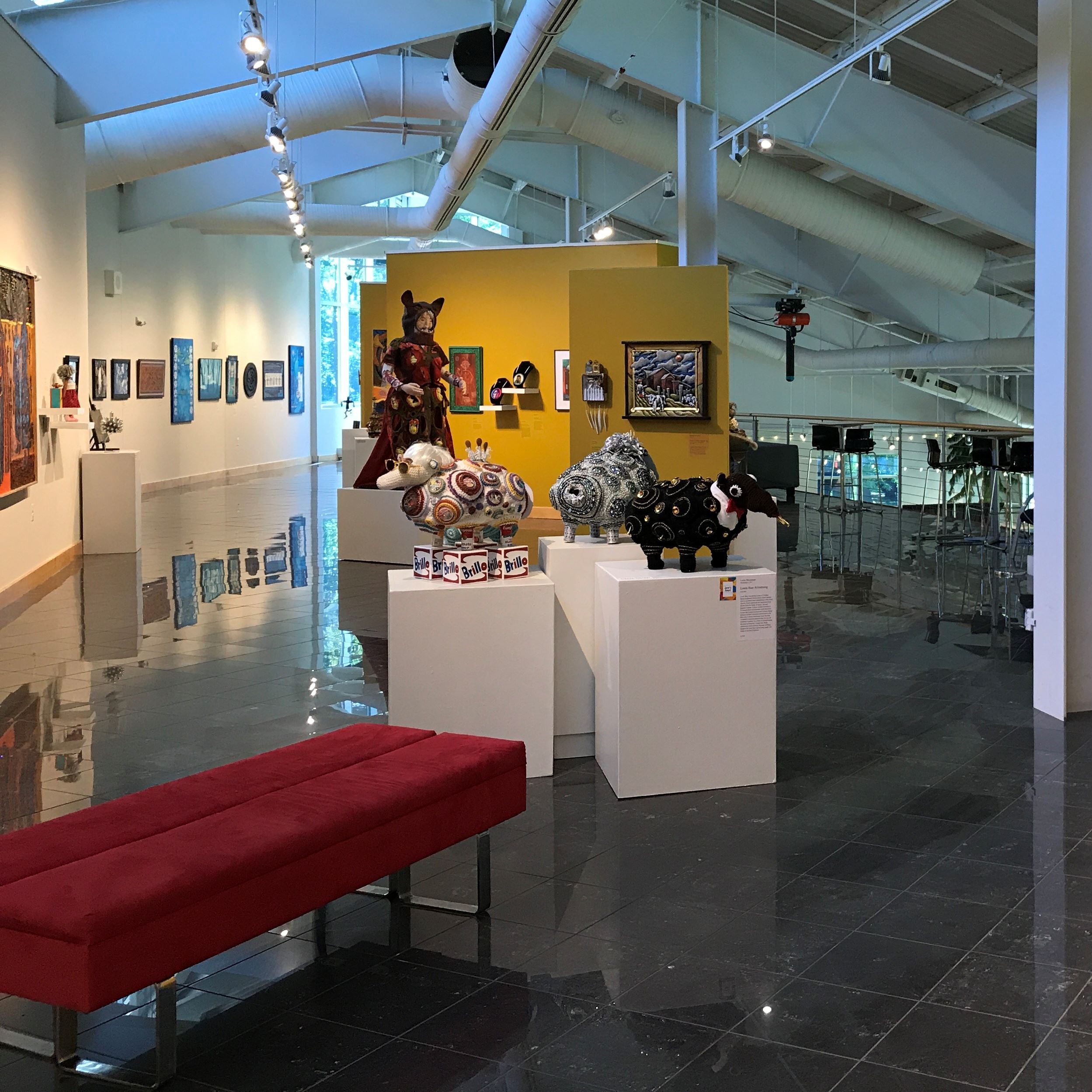 Exhibit room with artwork on the walls and on pedestals