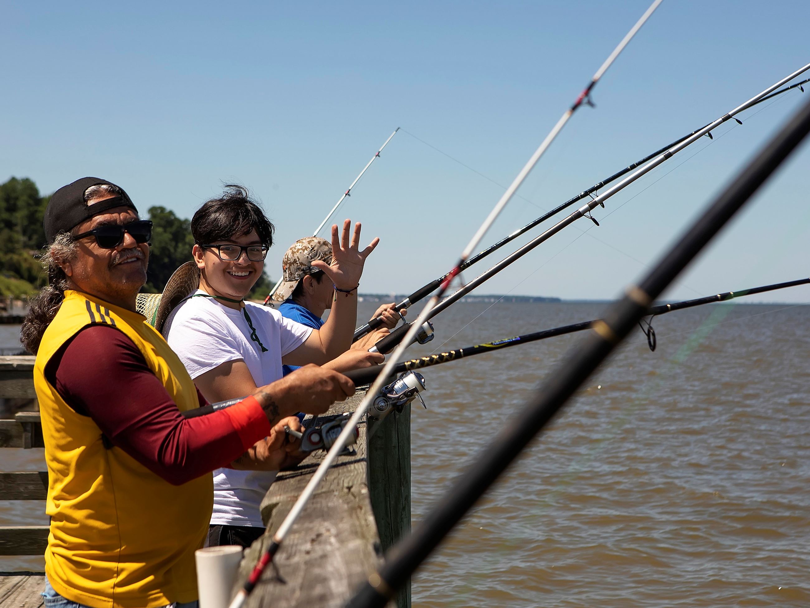 Man and son fishing off the pier at Breezy Point