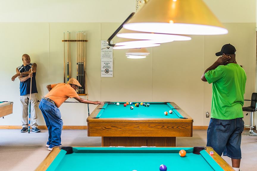 Three men playing pool