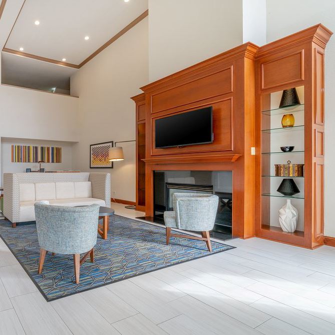 Room with a couch, chairs and a TV