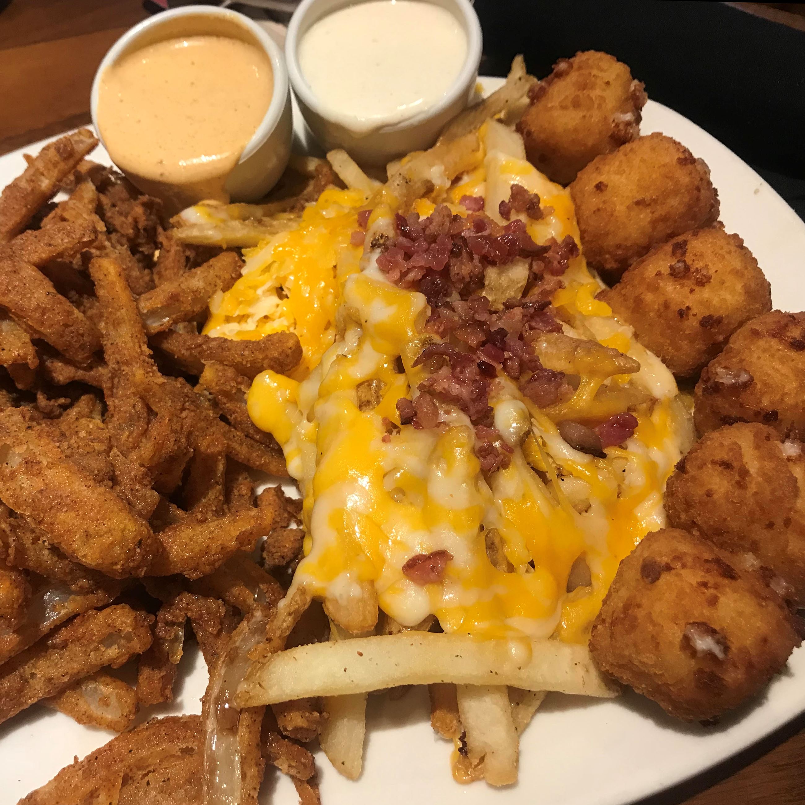 Appetizers with bacon cheese fries and dipping sauces
