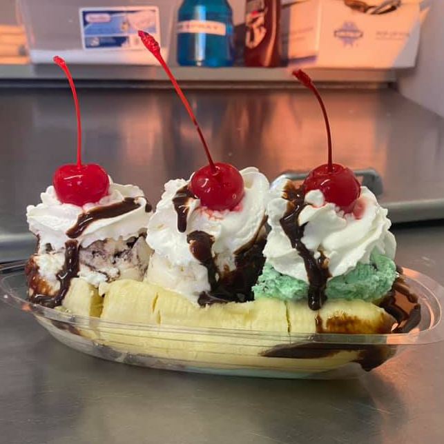 Banana split with cherries and whipped cream on top