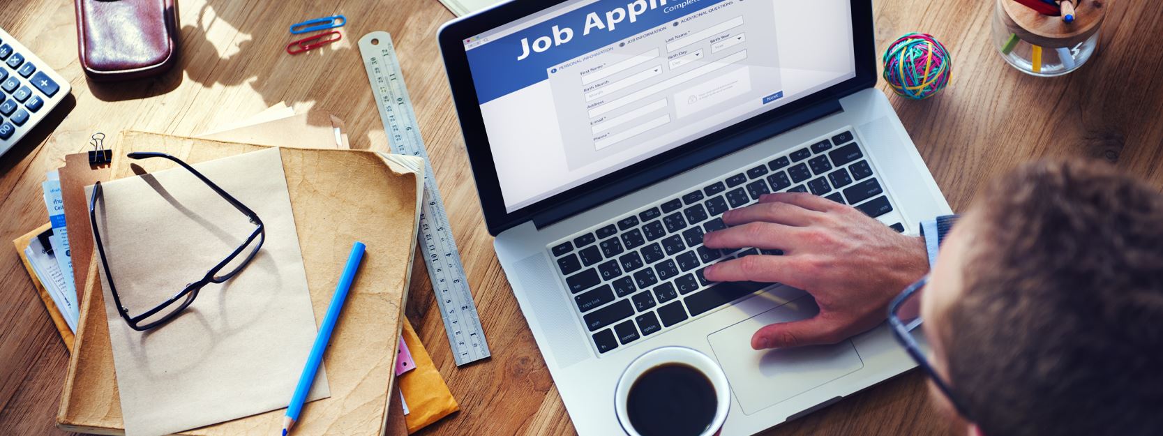 Man at a desk looking at a computer screen