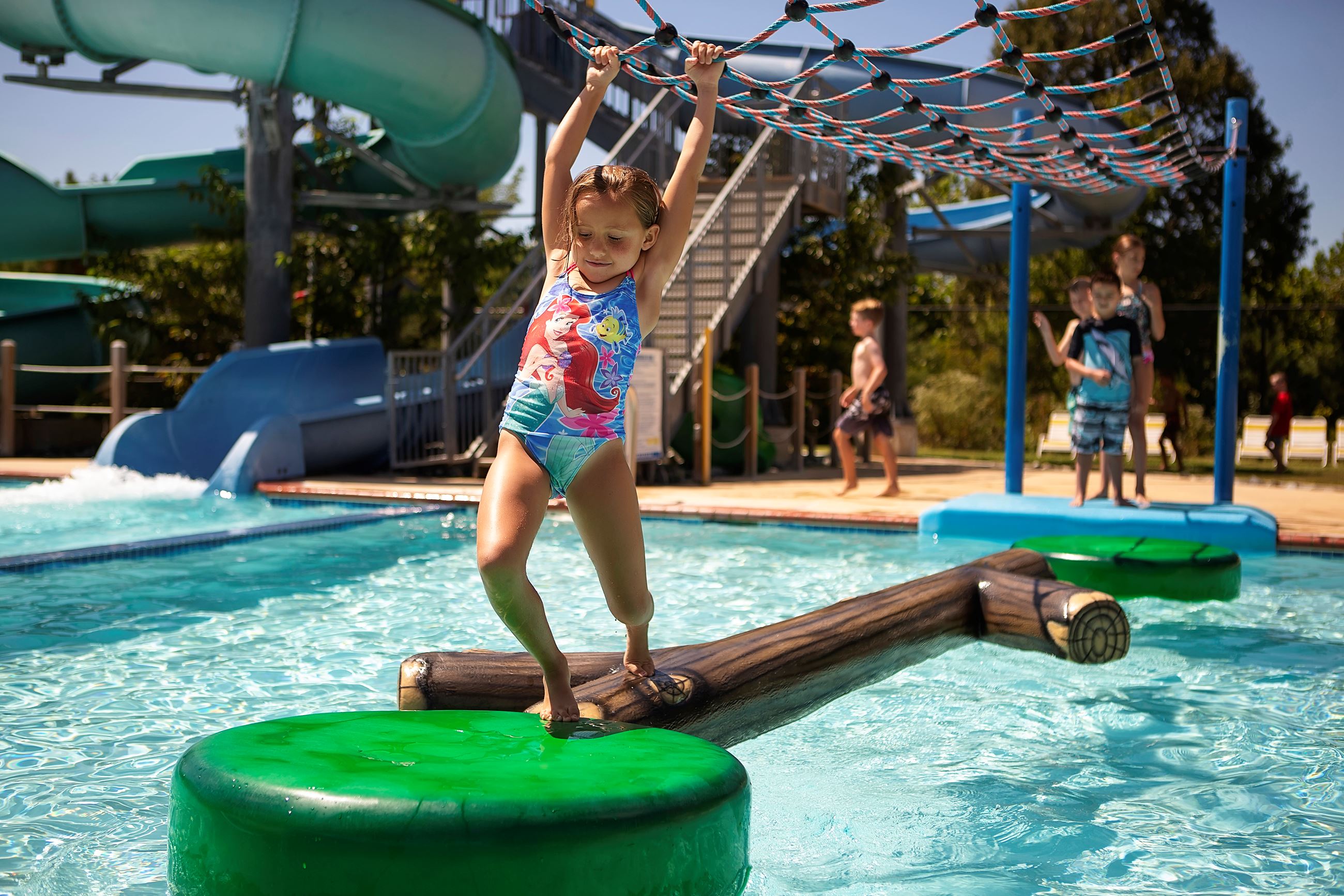 Child doing the obstacle course at Cove Point Pool