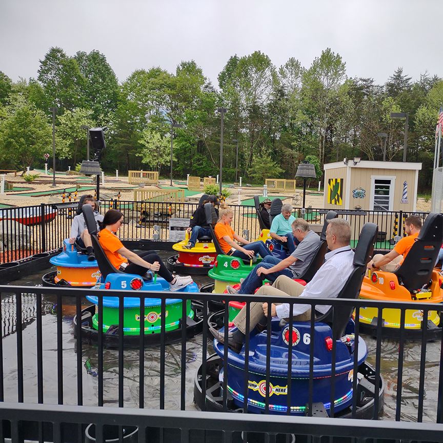 People riding on water bumper cars Opens in new window