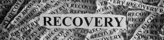 Ripped piece of paper that says recovery in front of other recovery papers